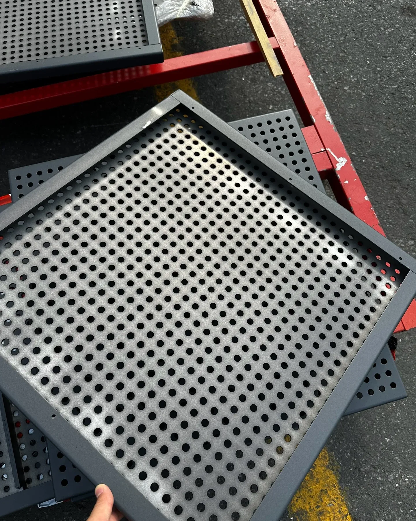 Close view of a framed round-hole perforated metal ceiling panel